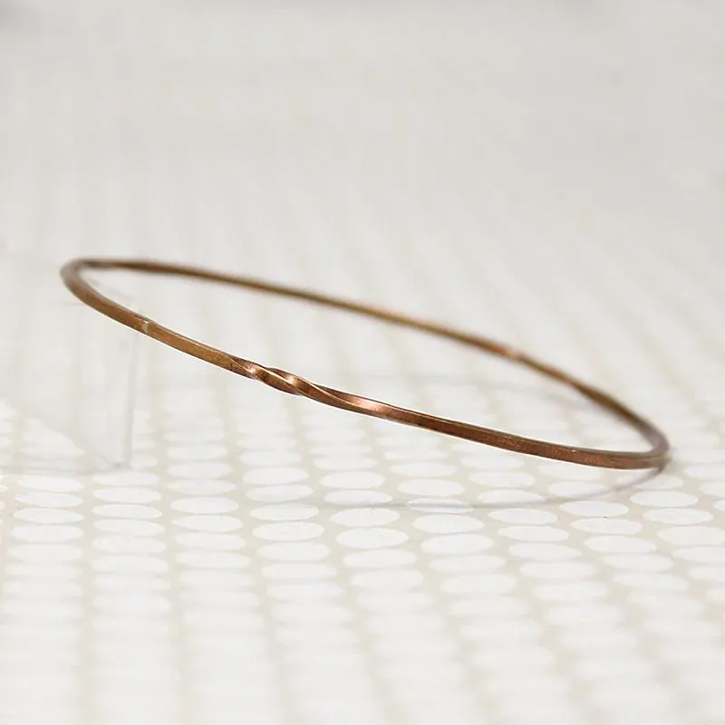 The Endless Twist Round Bangle in Bronze from Allie B.